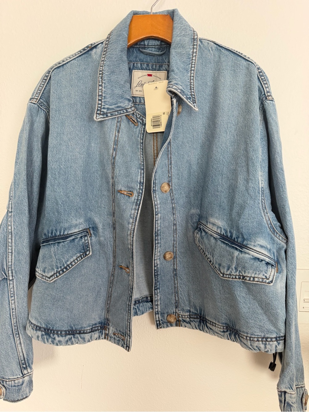 Levi's blouson style denim jacket in light blue. Button up- size medium.